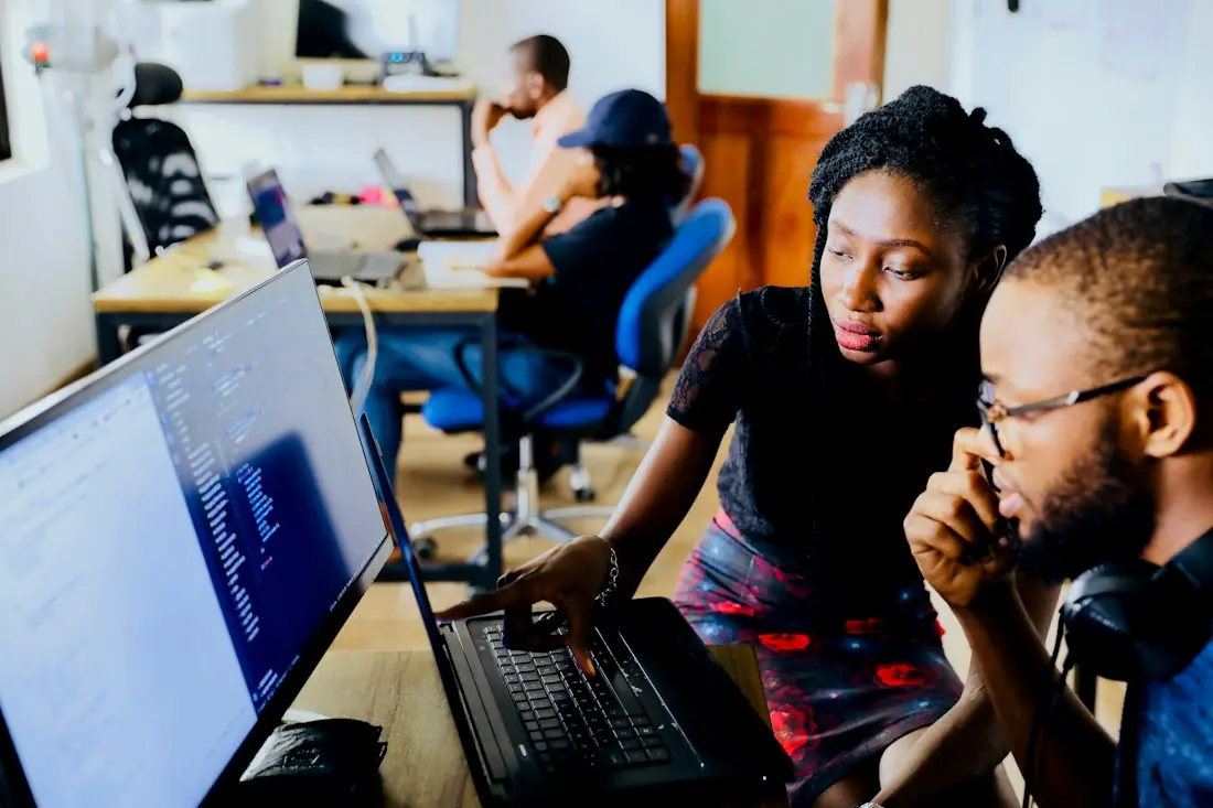 Two software developers reviewing code together